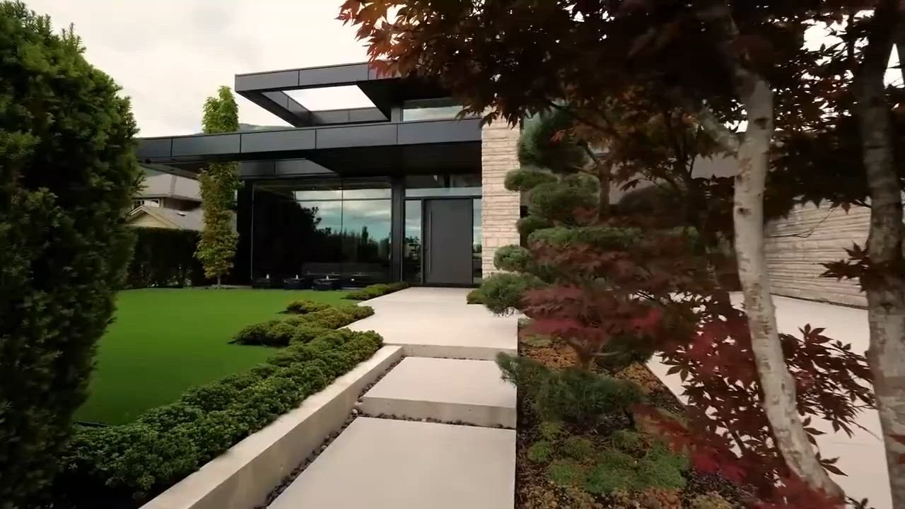 Modern home exterior with landscaped grounds at dusk